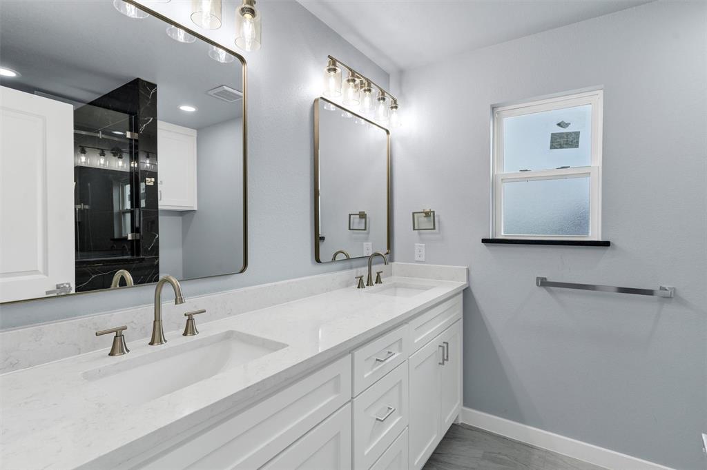 588 Highview Court Godley, TX 76044 - Photo 27 of 38 a bathroom with double vanity sinks and a mirror