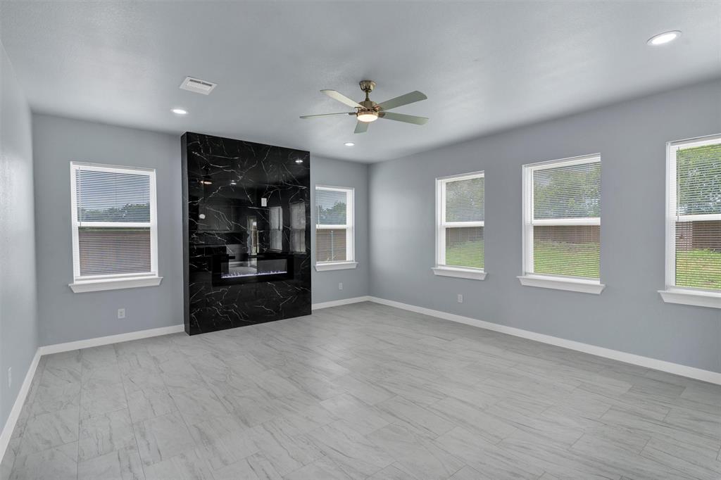 588 Highview Court Godley, TX 76044 - Photo 9 of 38 a view of an empty room with a window and kitchen view