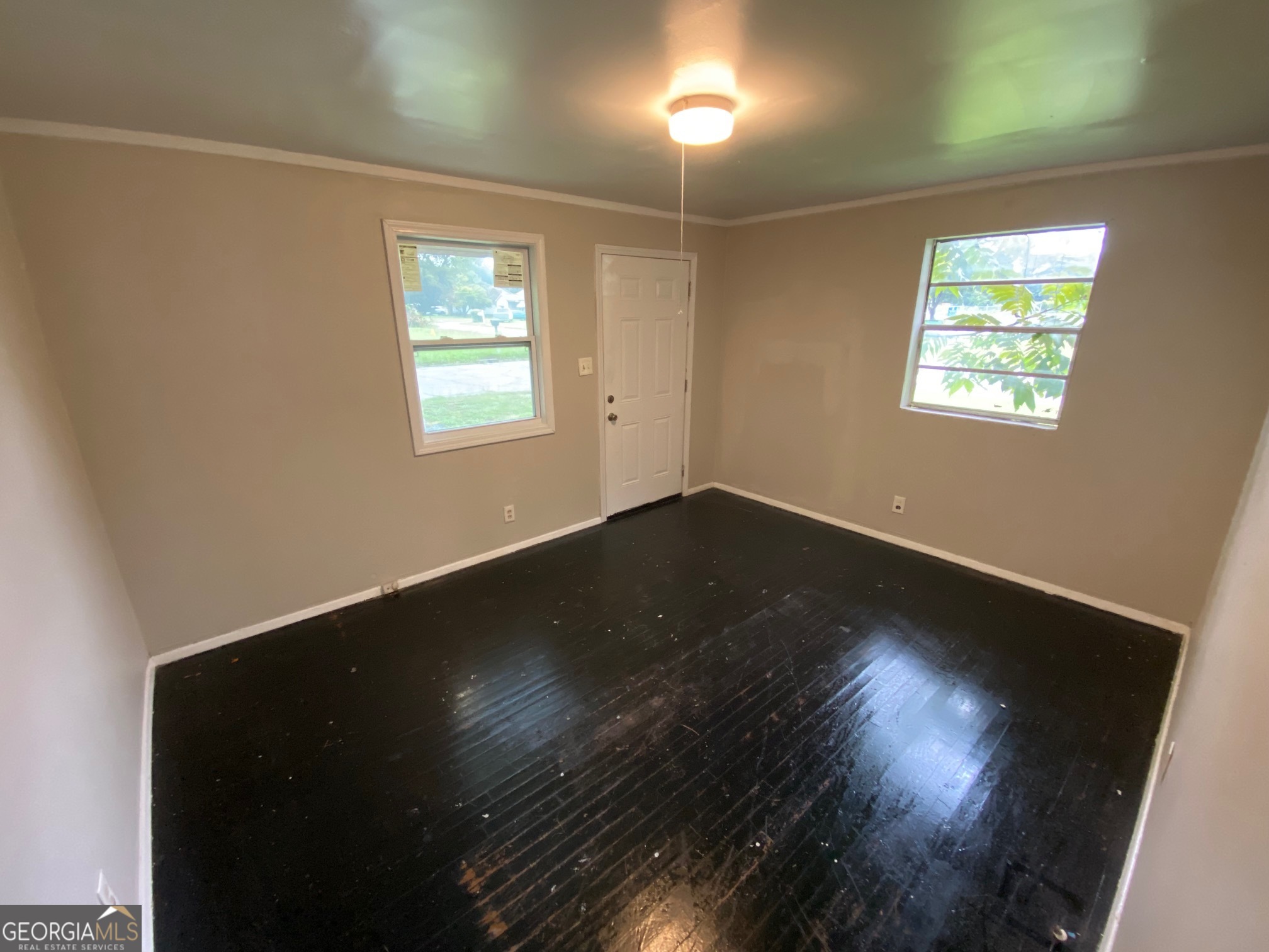 912 Thomas Street Macon, GA 31206 - Photo 3 of 23 an empty room with wooden floor and windows