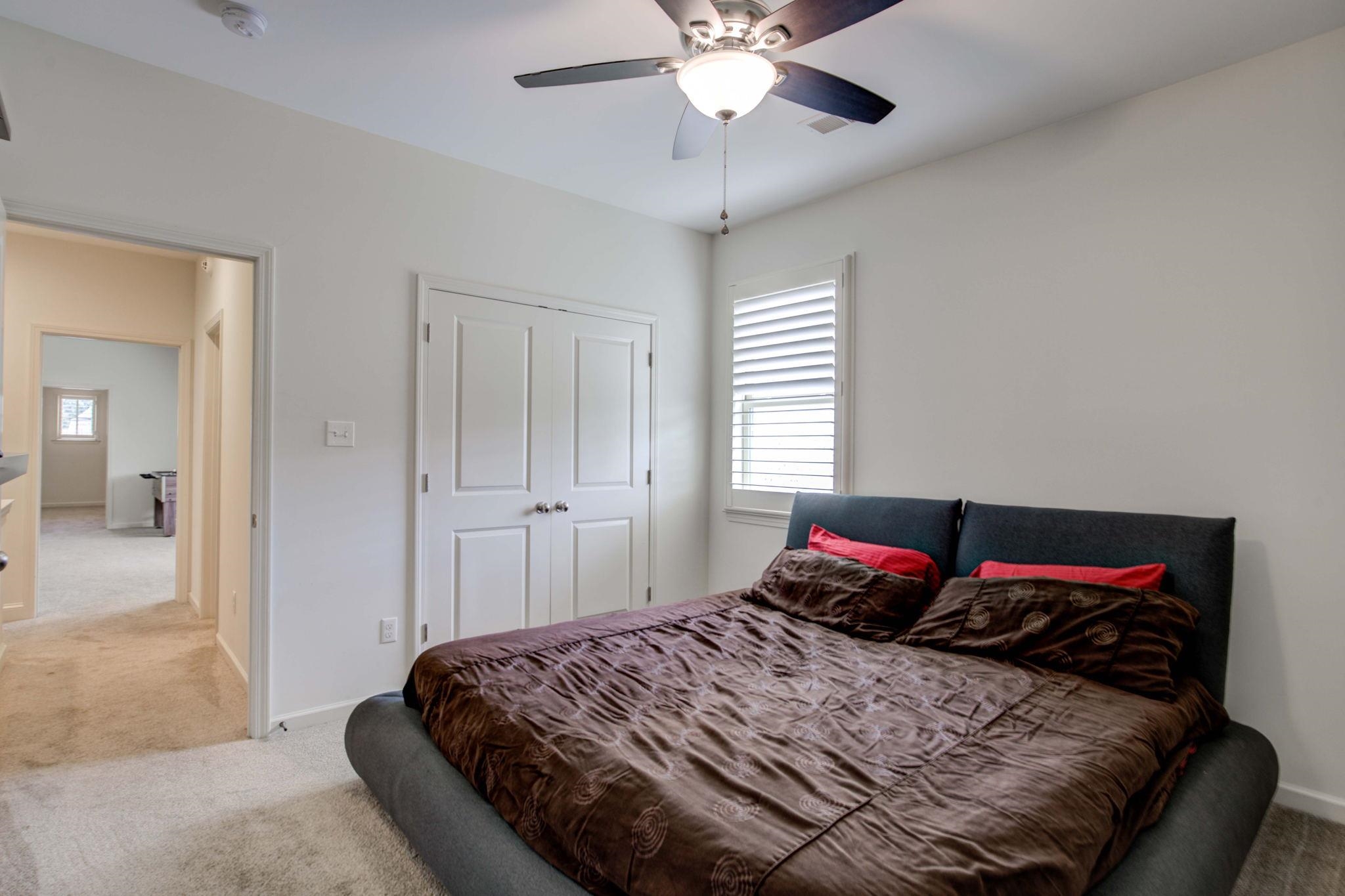 431 Kayley Cove Collierville, TN 38017 - Photo 17 of 24 a bedroom with a bed and a chandelier