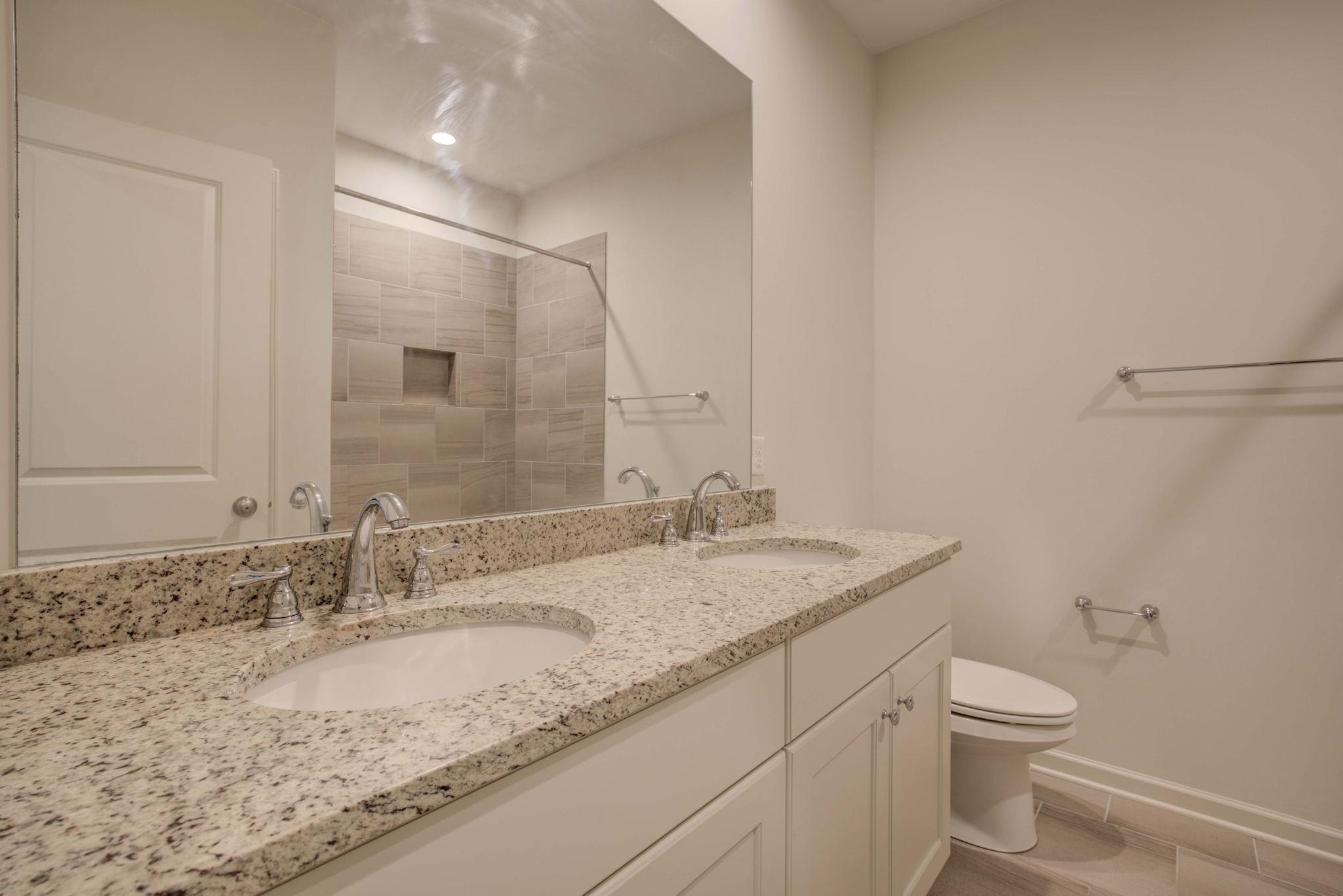 431 Kayley Cove Collierville, TN 38017 - Photo 18 of 24 a bathroom with a granite countertop sink a toilet and a mirror