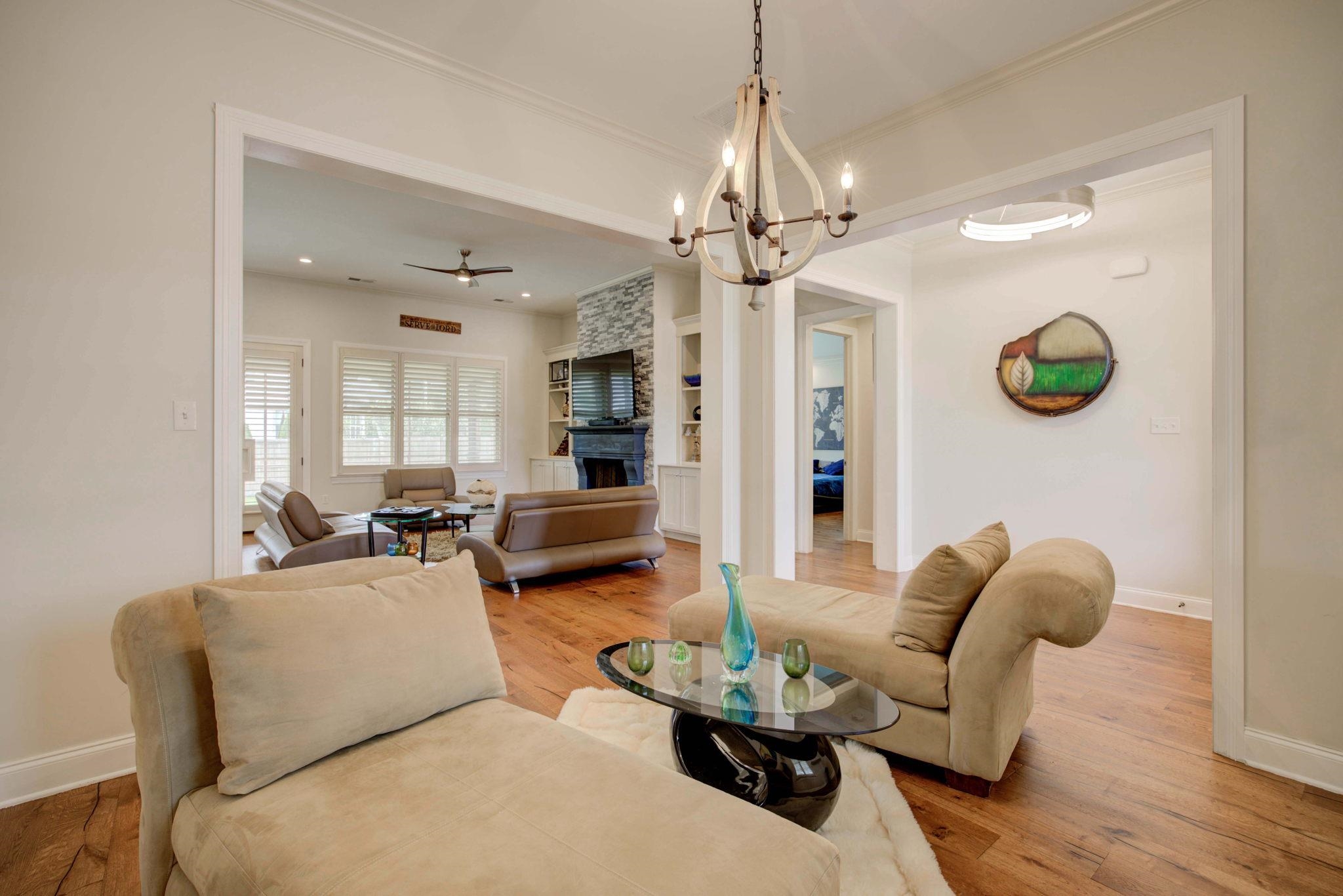 431 Kayley Cove Collierville, TN 38017 - Photo 10 of 24 a living room with furniture a chandelier and a flat screen tv
