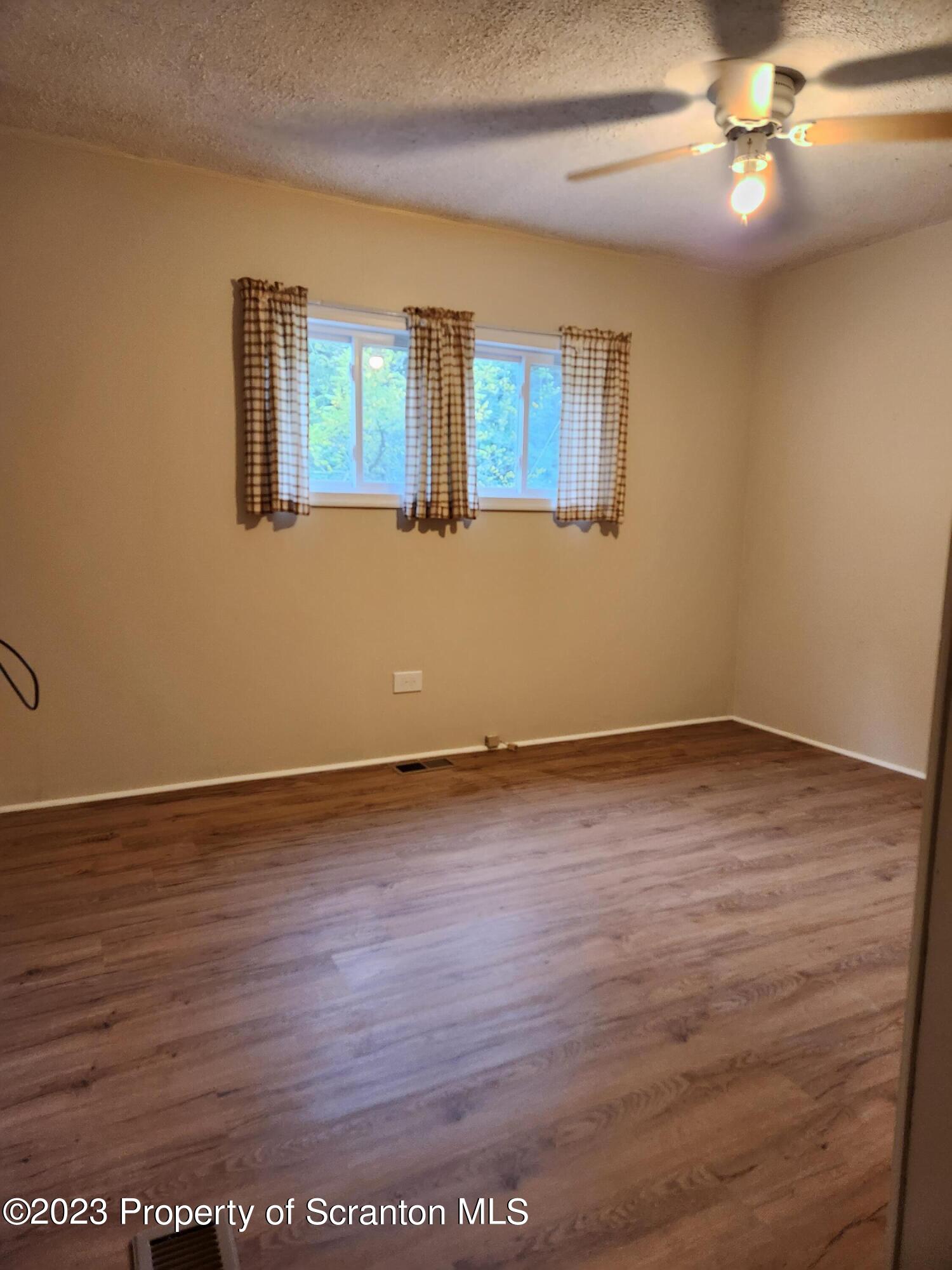 15325 Strickland Hill Road Springville, PA 18844 - Photo 14 of 20 wooden floor in an empty room with a window