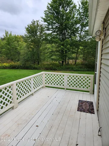 a wooden bench sitting in front of a yard