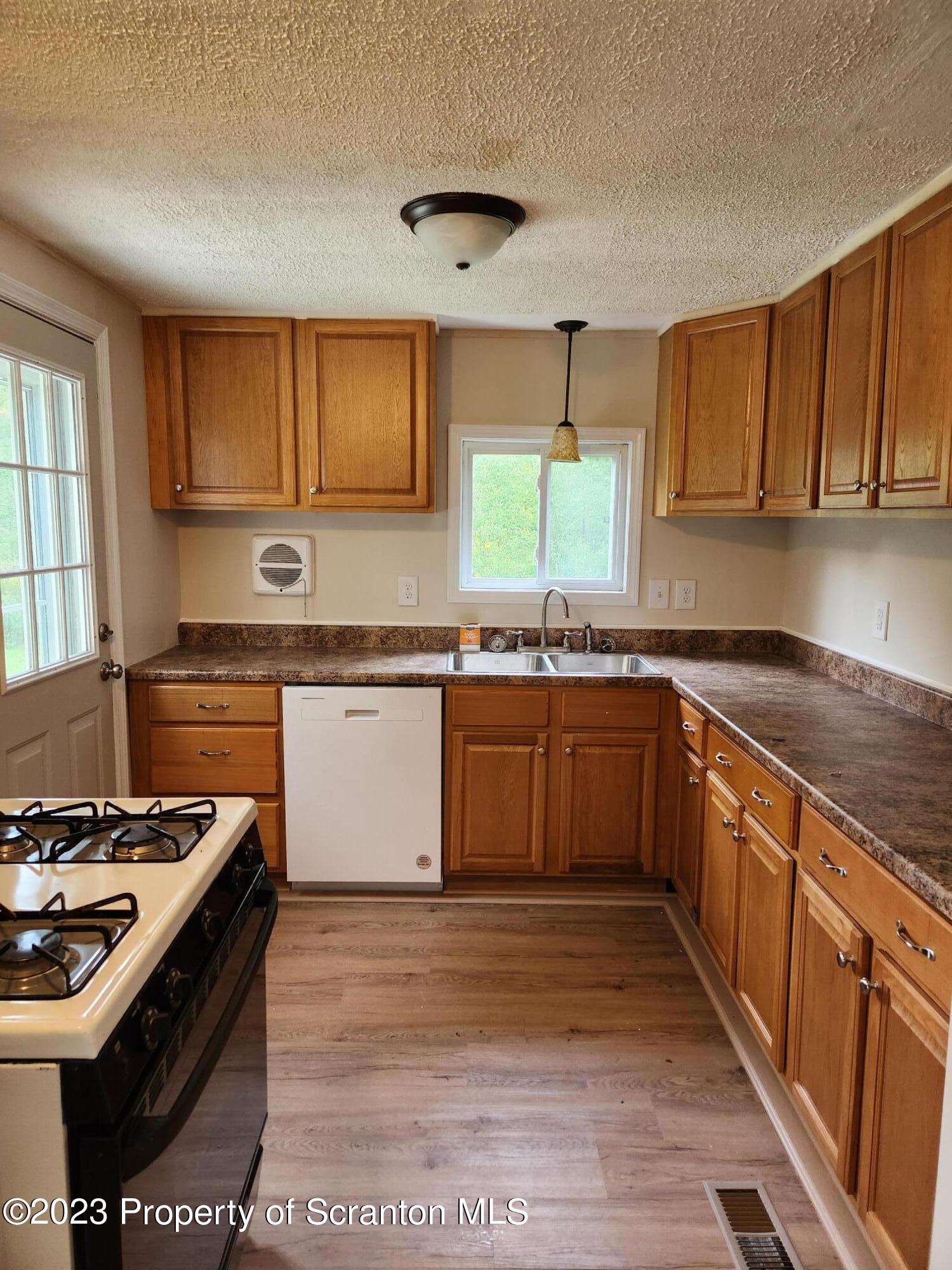15325 Strickland Hill Road Springville, PA 18844 - Photo 8 of 20 a kitchen with stainless steel appliances granite countertop a stove a sink dishwasher and a refrigerator