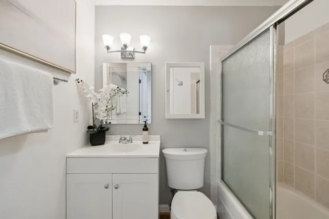 a bathroom with a sink toilet and shower