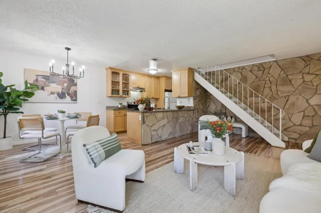 a living room with furniture and kitchen view