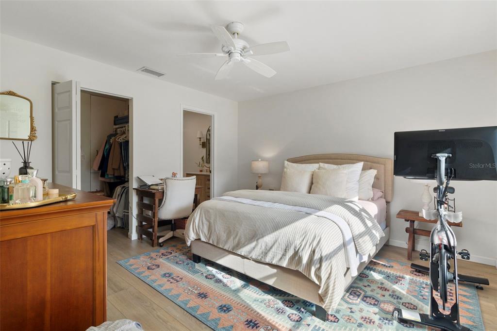 3641 Longmeadow, Unit 33 Sarasota, FL 34235 - Photo 10 of 18 a bedroom with a bed and wooden floor