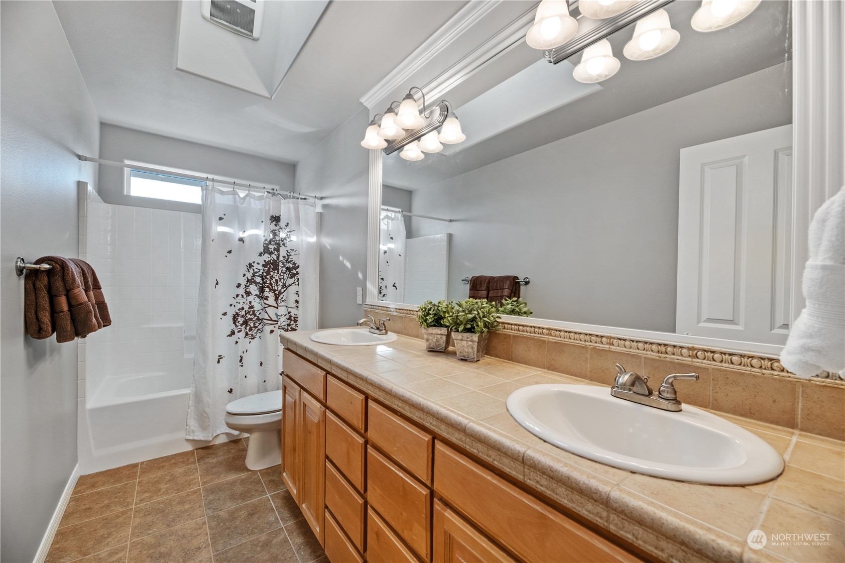 4026 214th Street Southeast Bothell, WA 98021 - Photo 30 of 34 a bathroom with a granite countertop sink a toilet a mirror and shower