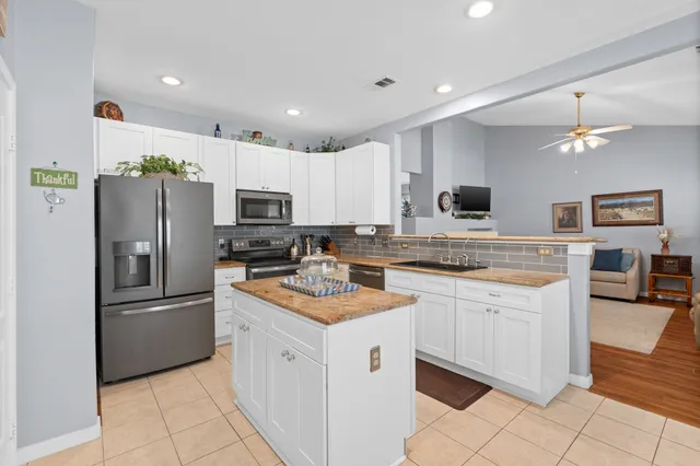a kitchen with a sink dining table and chairs