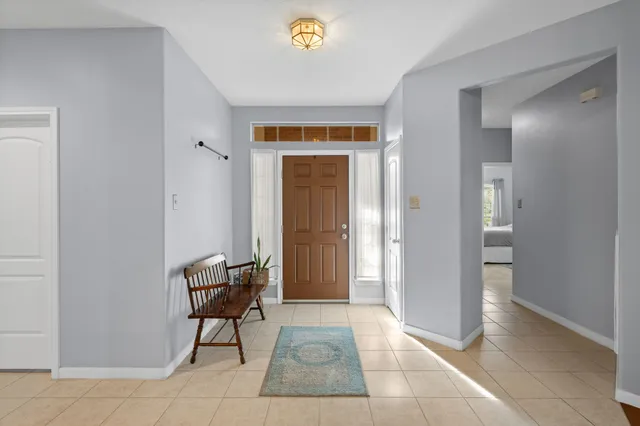 a dining room with furniture a chandelier and wooden floor