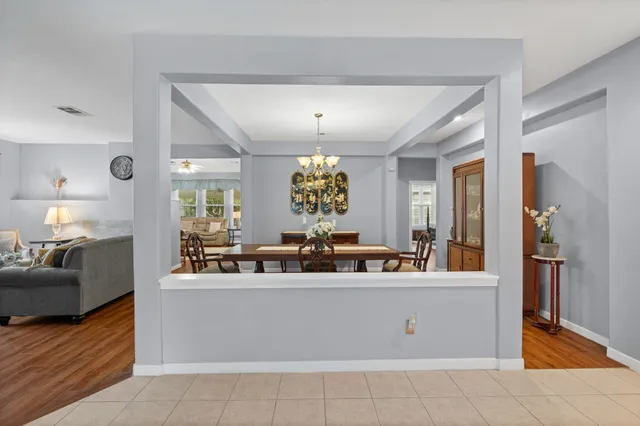a view of a dining room with furniture wooden floor and chandelier