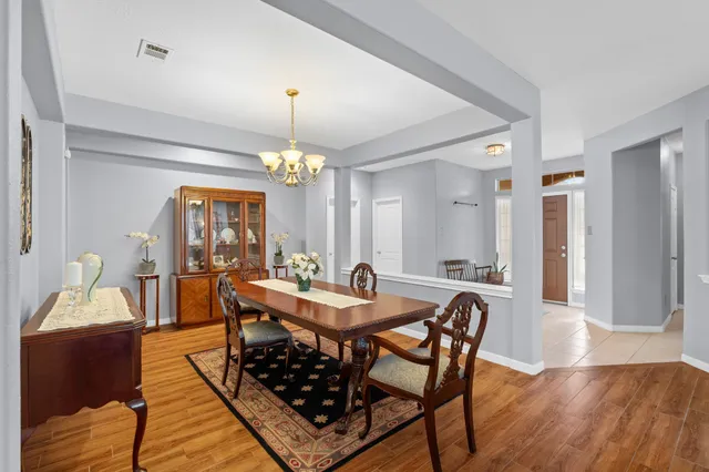 a view of a dining room with furniture and wooden floor