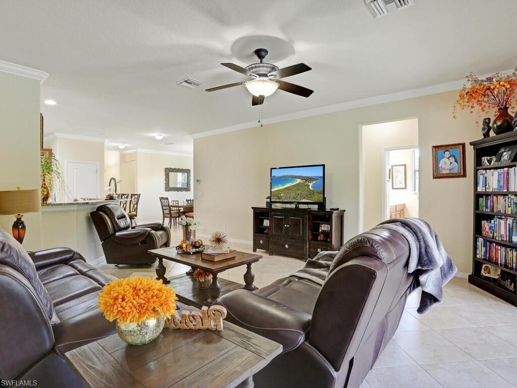 8143 Monticello Court Naples, FL 34104 - Photo 11 of 26 a living room with furniture or couch and a chandelier