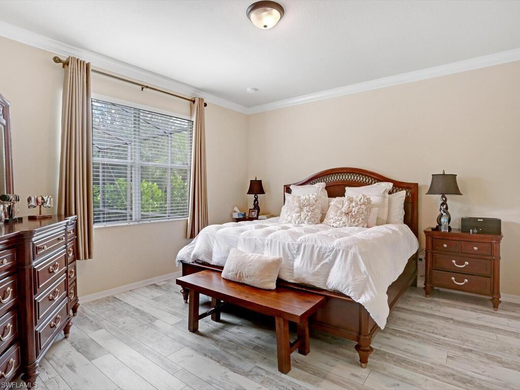 8143 Monticello Court Naples, FL 34104 - Photo 14 of 26 a bedroom with a bed and a window