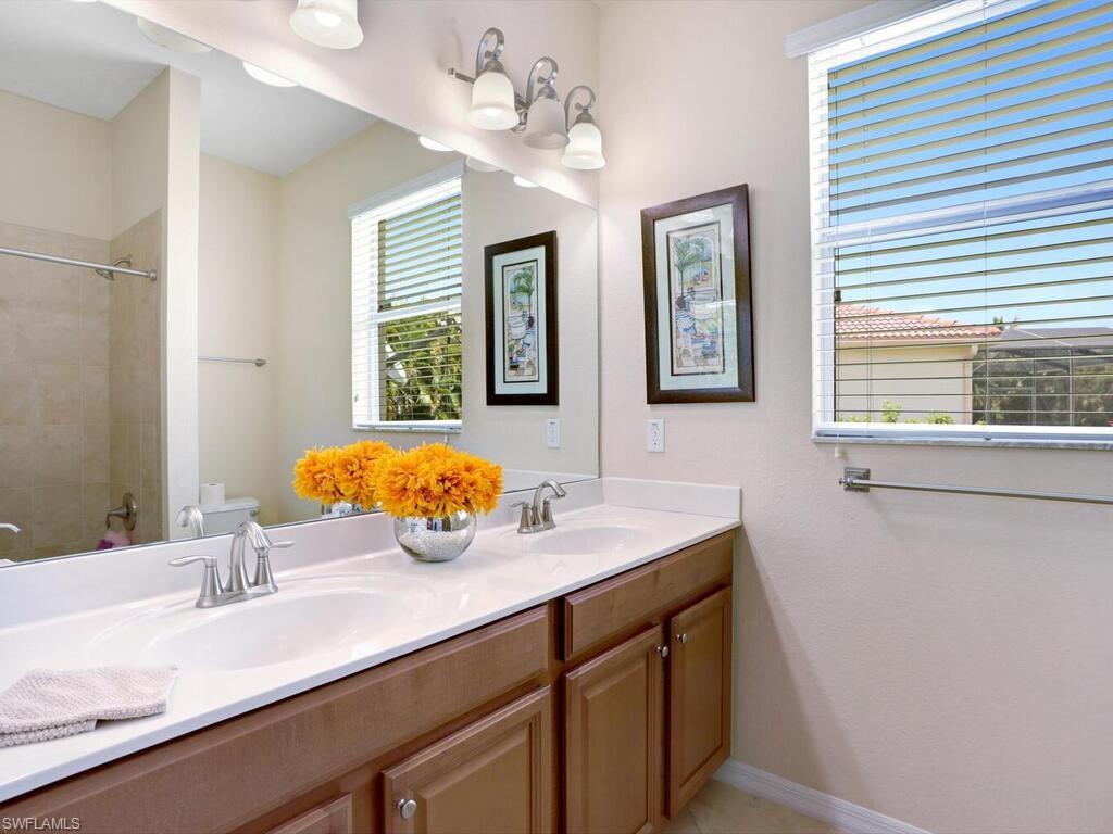 8143 Monticello Court Naples, FL 34104 - Photo 17 of 26 a bathroom with a sink double vanity and a mirror