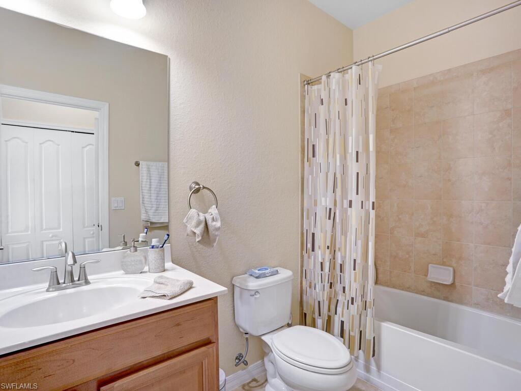 8143 Monticello Court Naples, FL 34104 - Photo 19 of 26 a bathroom with a sink a toilet and shower