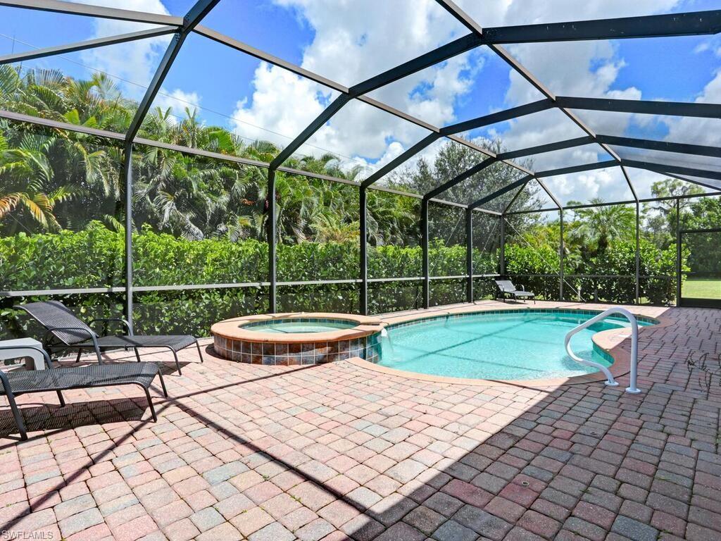 8143 Monticello Court Naples, FL 34104 - Photo 21 of 26 a view of a swimming pool with a porch