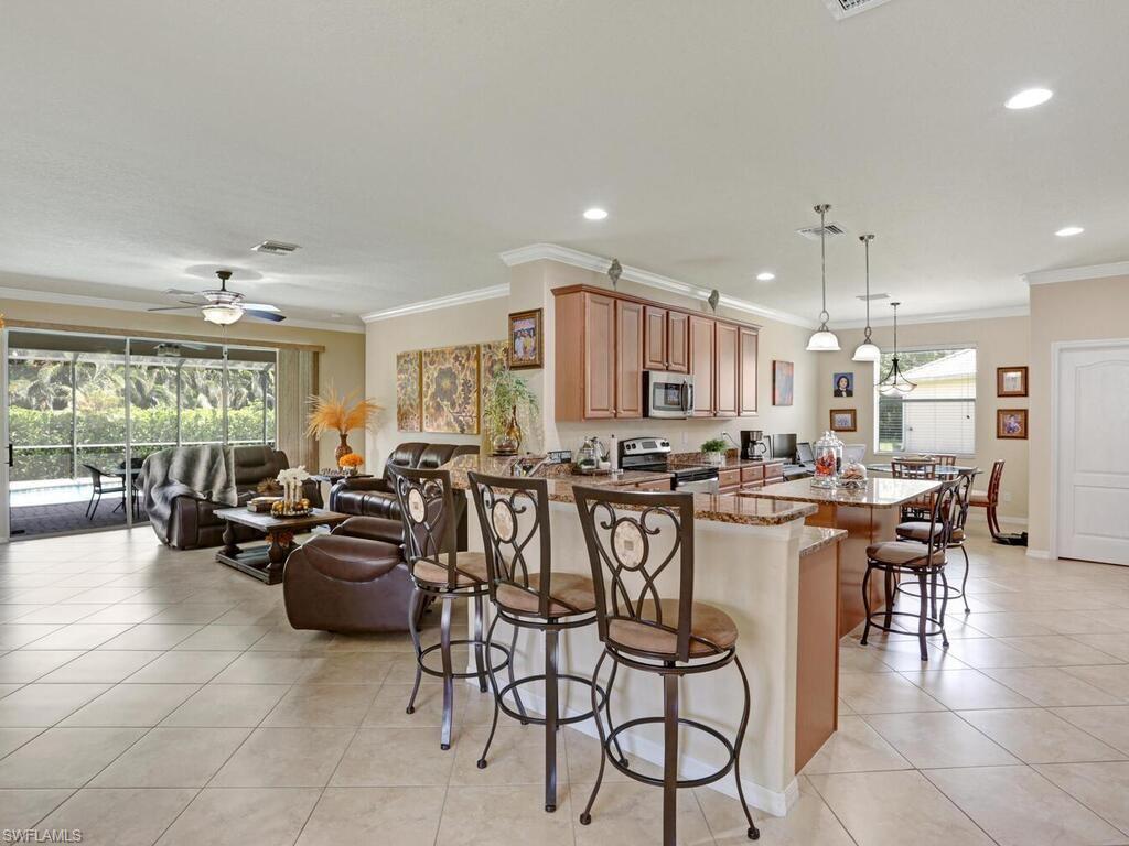 8143 Monticello Court Naples, FL 34104 - Photo 3 of 26 a large kitchen with a table and chairs