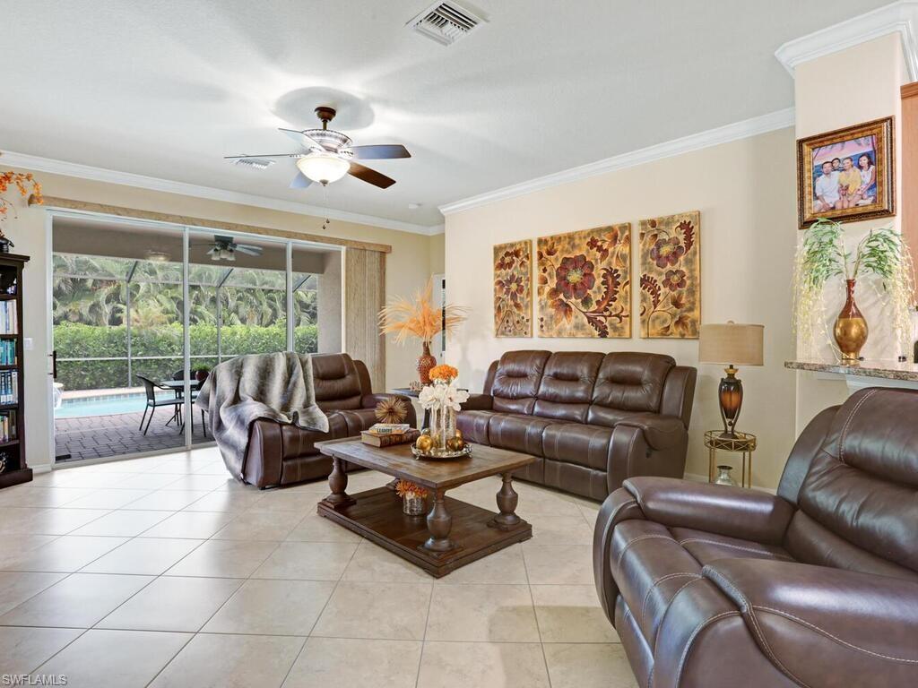 8143 Monticello Court Naples, FL 34104 - Photo 9 of 26 a living room with furniture and a large window