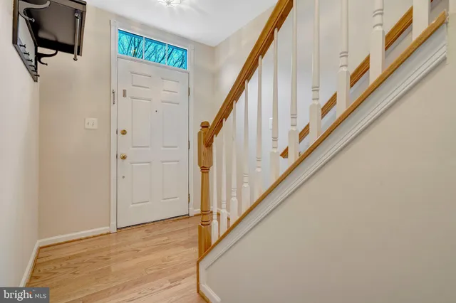 a view of an entryway with wooden floor