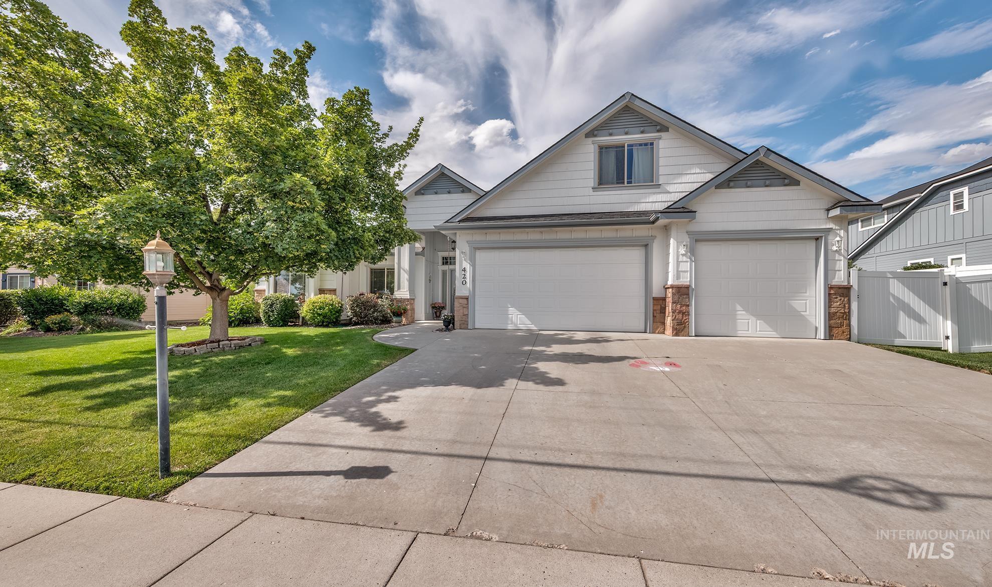 420 West Indianhead Road Weiser, ID 83672 - Photo 3 of 40 White siding residence with two attached garage bays featuring stone accents