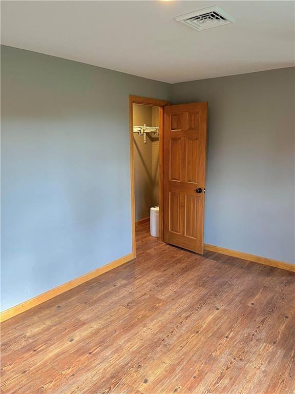 8018 De Villars Road Cochranton, PA 16314 - Photo 15 of 25 a view of an empty room with wooden floor and a window