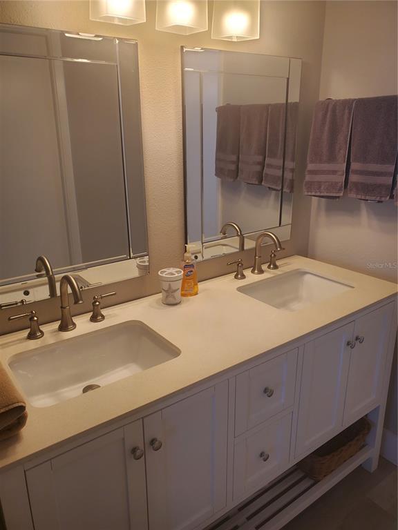 4401 Gulf Of Mexico Drive, Unit 703 Longboat Key, FL 34228 - Photo 13 of 23 a bathroom with a sink and a mirror