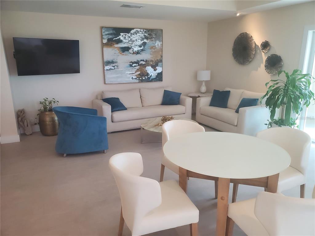 4401 Gulf Of Mexico Drive, Unit 703 Longboat Key, FL 34228 - Photo 14 of 23 a living room with furniture and a flat screen tv