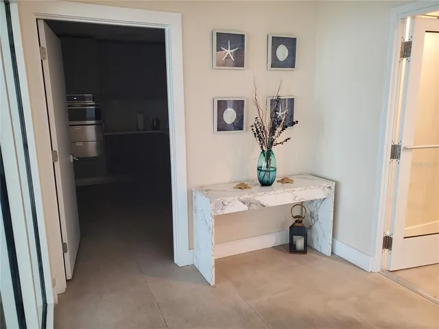 a view of kitchen with sink and refrigerator
