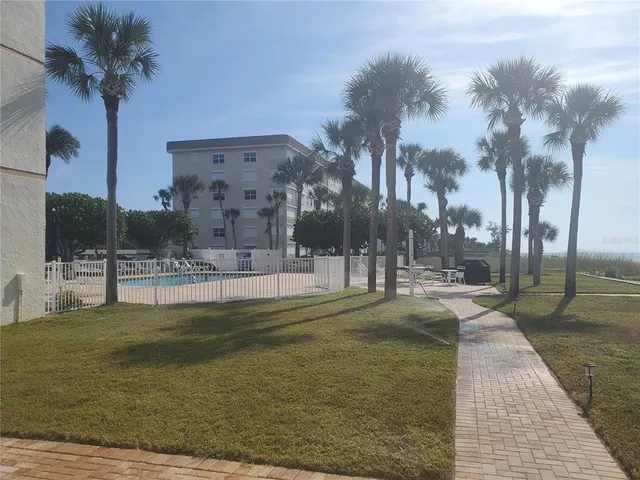 a swimming pool with outdoor seating and yard