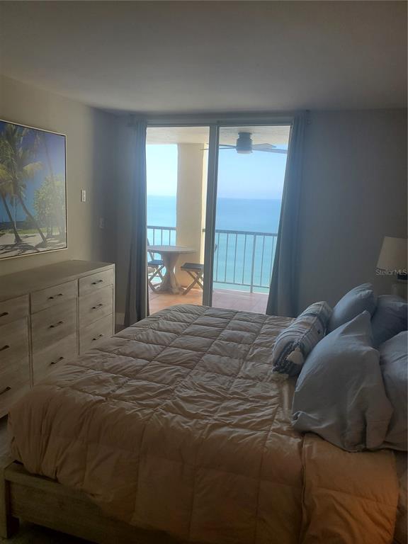 4401 Gulf Of Mexico Drive, Unit 703 Longboat Key, FL 34228 - Photo 7 of 23 a bed sitting in a bedroom next to a window