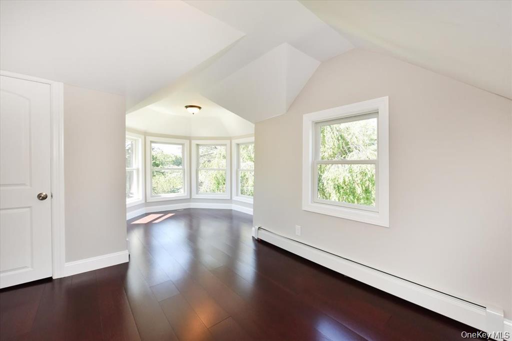 87 Dunlop Road Huntington, NY 11743 - Photo 23 of 31 an empty room with wooden floor and windows
