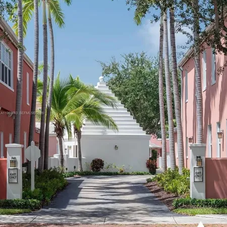 a kitchen with stainless steel appliances kitchen island granite countertop a stove a sink and a white cabinets
