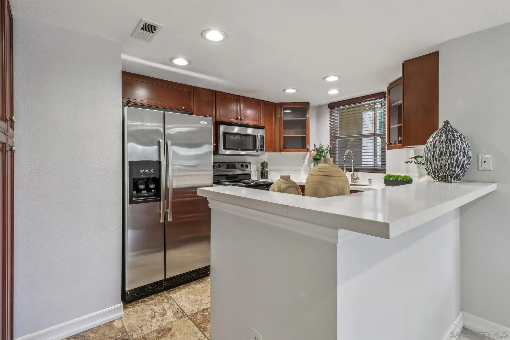15373 Maturin Drive, Unit 178 San Diego, CA 92127 - Photo 11 of 61 a kitchen with stainless steel appliances granite countertop a refrigerator and a sink