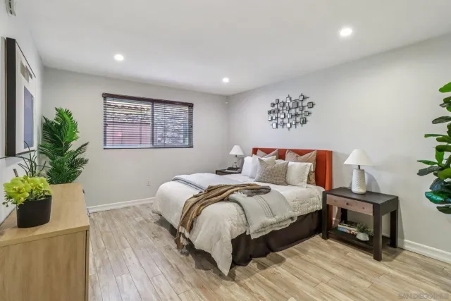 a bed sitting in a bedroom next to a window