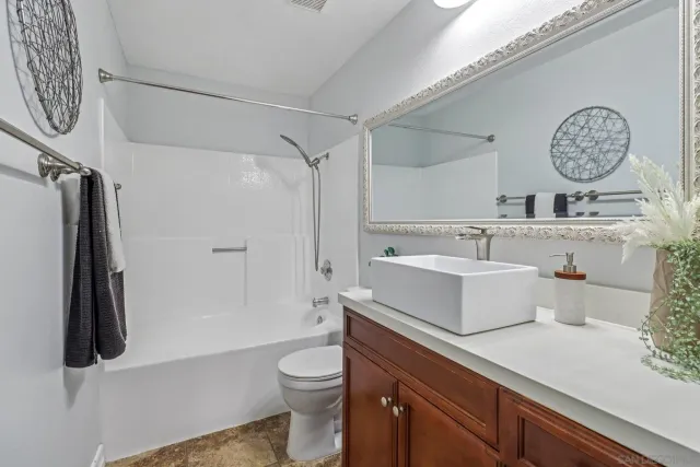 a bathroom with a sink a toilet and a shower