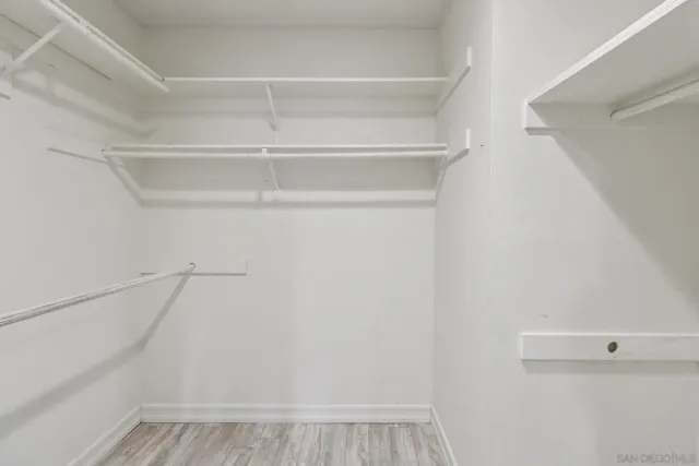 a view of walk in closet with empty racks