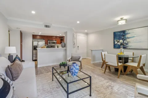 a living room with furniture a rug and white walls
