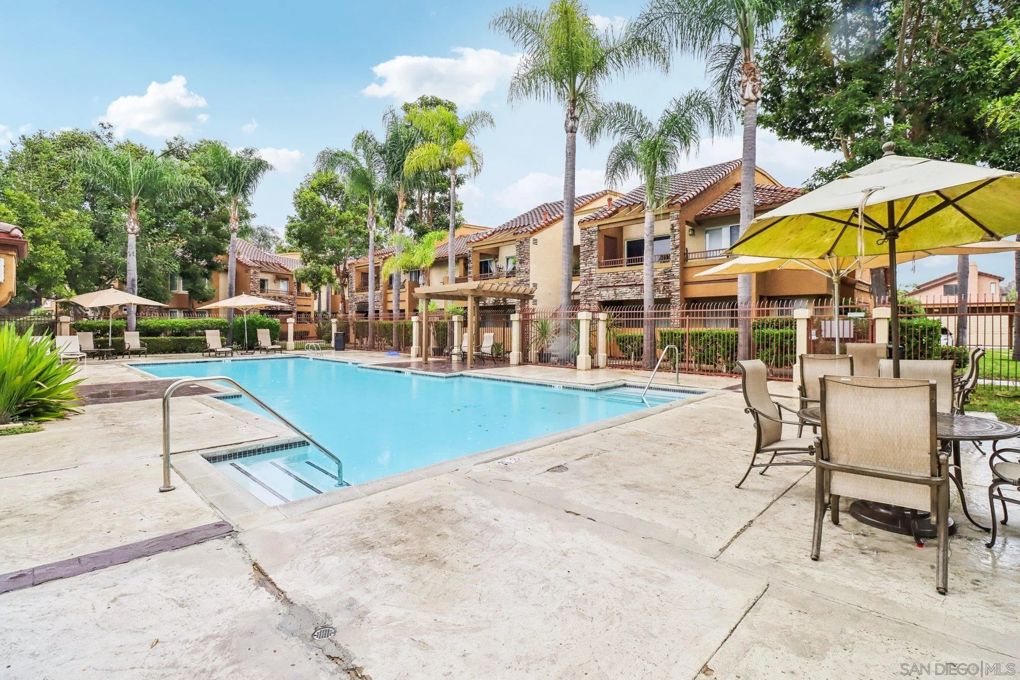 15373 Maturin Drive, Unit 178 San Diego, CA 92127 - Photo 38 of 61 a view of swimming pool with lawn chairs under an umbrella