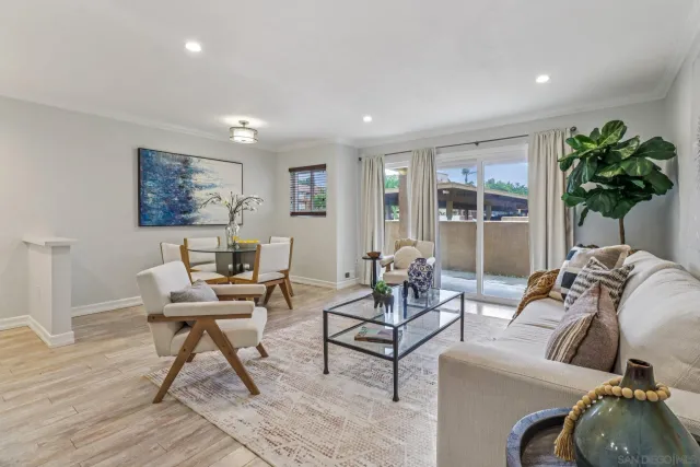 a living room with furniture and a potted plant