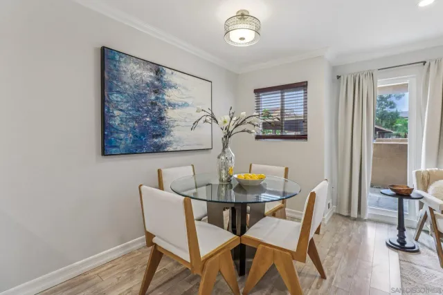 a view of a dining room with furniture and a window