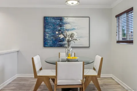 a dining room with furniture and wooden floor