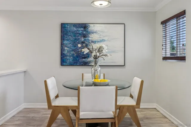 a dining room with furniture and wooden floor