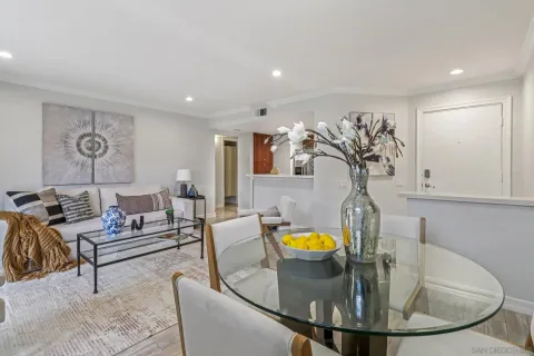 a living room with furniture and kitchen view