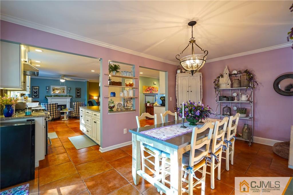 36 Starkin Road Edison, NJ 08837 - Photo 14 of 45 a view of a dining room and livingroom with furniture wooden floor a chandelier