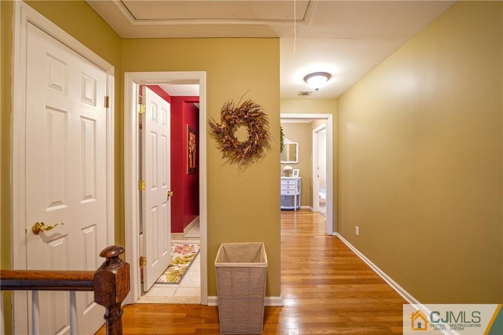 36 Starkin Road Edison, NJ 08837 - Photo 19 of 45 a view of a hallway with wooden floor and staircase