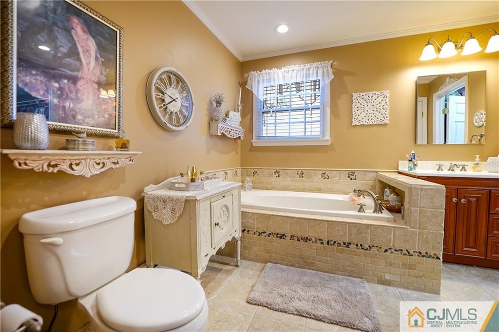 36 Starkin Road Edison, NJ 08837 - Photo 31 of 45 a bathroom with a toilet a sink and a bathtub
