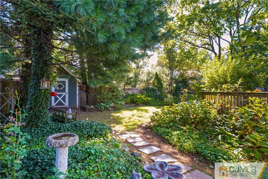 36 Starkin Road Edison, NJ 08837 - Photo 43 of 45 a backyard of a house with lots of green space and fountain