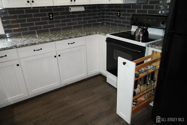 a kitchen with granite countertop a sink and cabinets